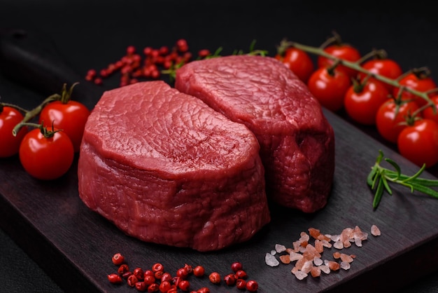 Raw beef eye steak round with salt spices and herbs