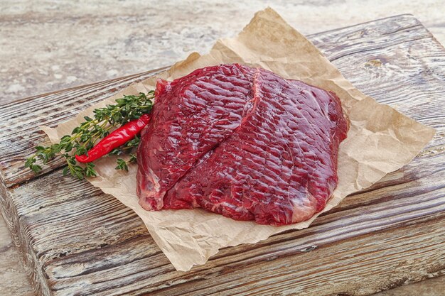 Raw beef machete steak for grill served thyme