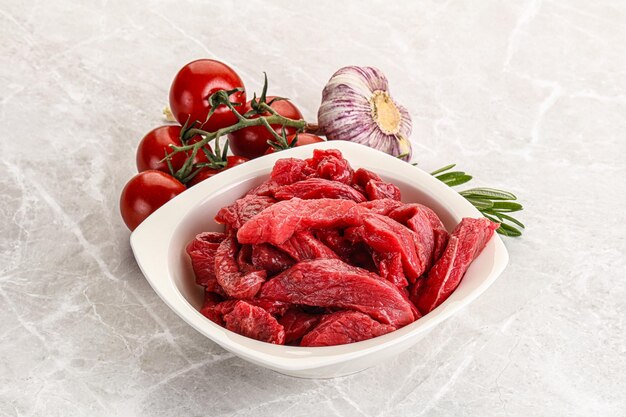 Raw beef meat for cooking served rosemary