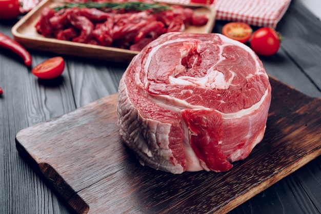 Raw beef meat fillet on wooden board close up