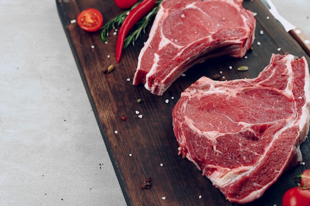 Raw beef meat fillet on wooden board