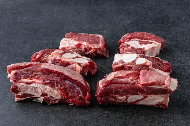 Raw beef meat osso buco shank steak italian ossobuco Black background