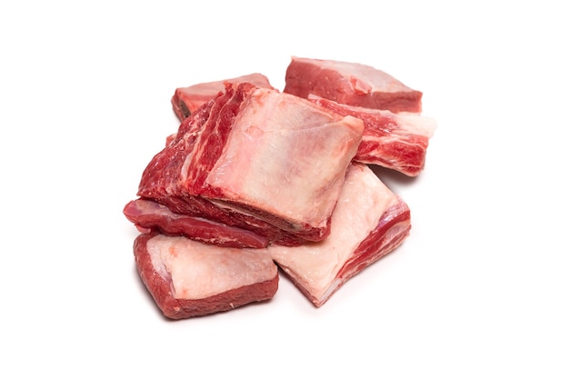 Raw beef ribs isolated on white surface. Top view.