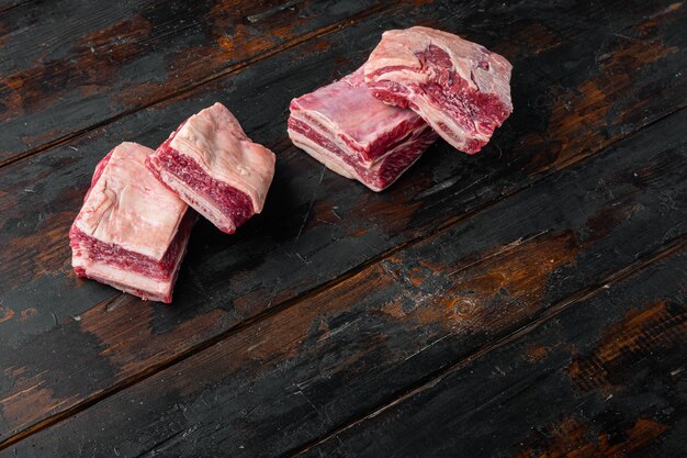 Raw beef ribs kalbi set, on old dark  wooden table background, with copy space for text