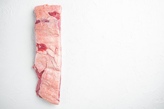 Raw beef ribs kalbi set, on white stone  background, top view flat lay, with copy space for text