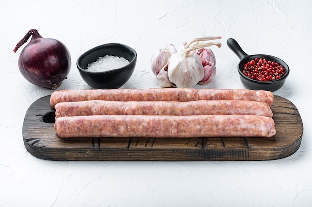 Raw beef sausages, on white table