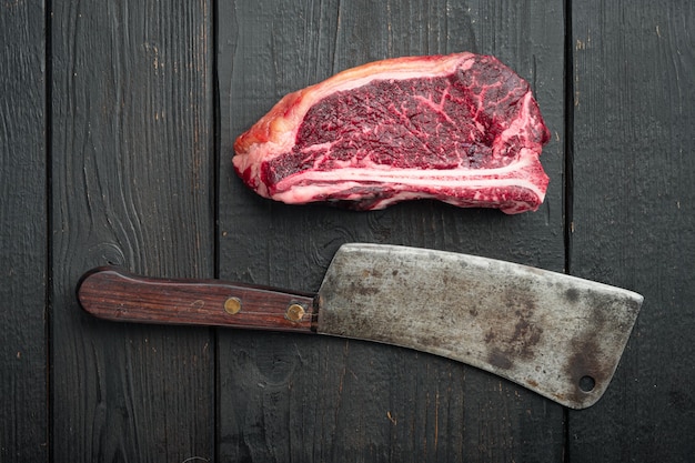 Raw beef steak Club steak cut, on black wooden table