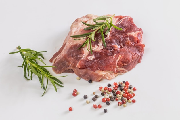 Raw beef steak and ingredients on white background