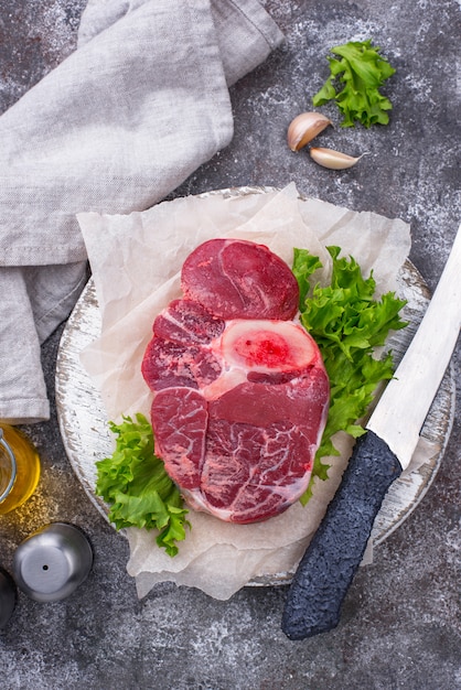 Raw beef steak ossobuco on cutting board