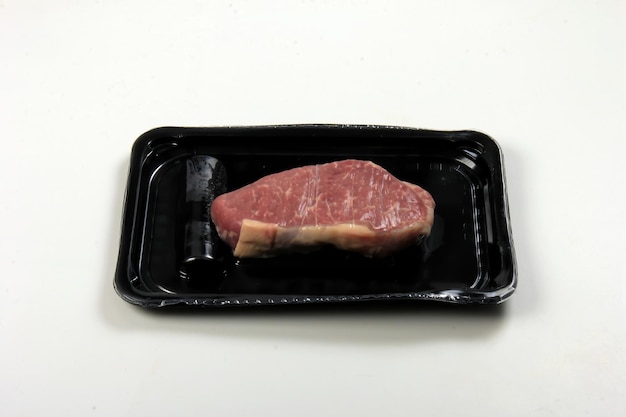 Raw beef steak vacuum set, sirloin steak on black plastic\
package