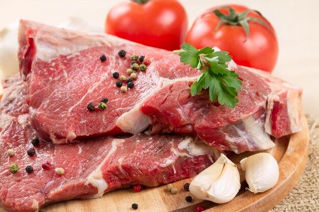 Raw beef steak with garlic and pepper