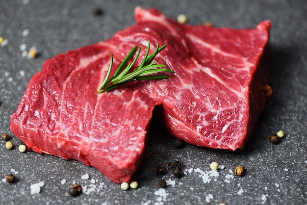 Raw beef steak with herb and spices - Fresh meat beef sliced on black surface