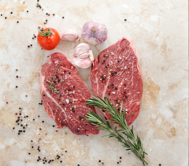 Raw beef steak with rosemary