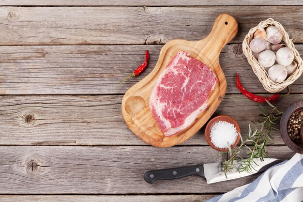 Raw beef steak with spices and herbs