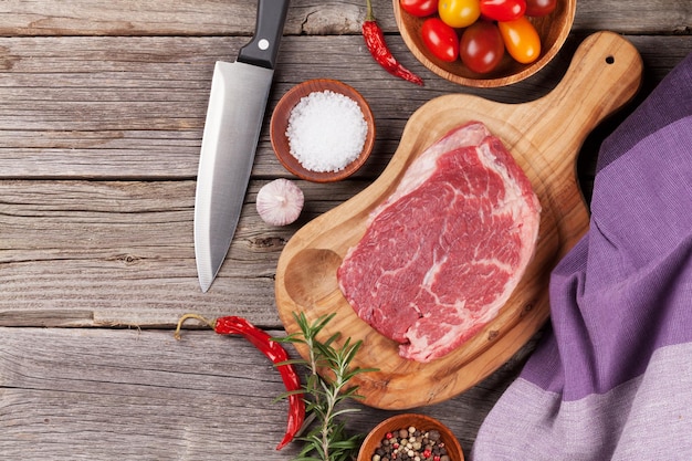 Raw beef steak with spices and herbs