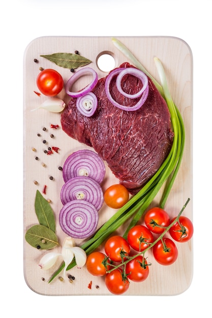 Raw beef steak with spices isolated on white surface