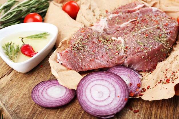 Raw beef steak on wooden table