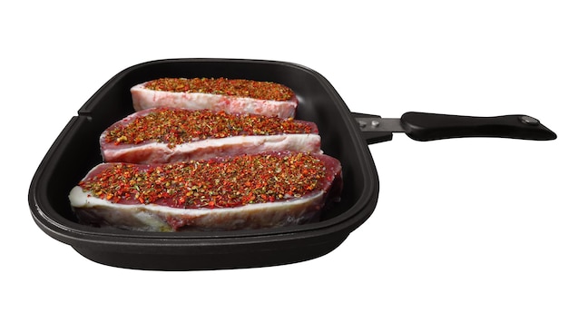 Raw beef steaks in a pan