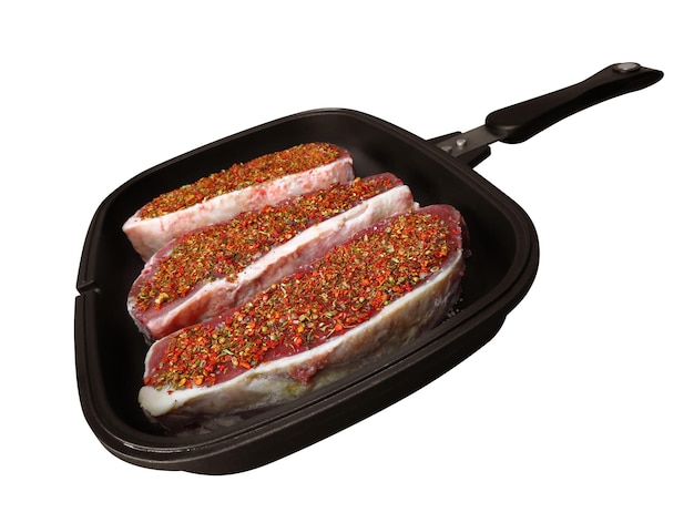 Raw beef steaks in a pan