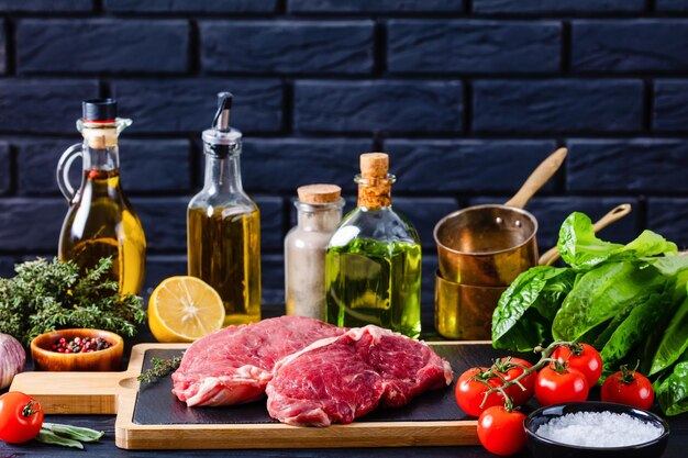 Raw beef steaks on a wood board