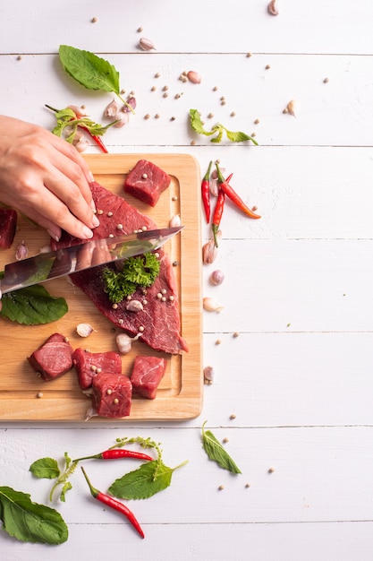 Raw beef on white wood background 