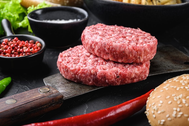 Raw beef with ingredients for a burger