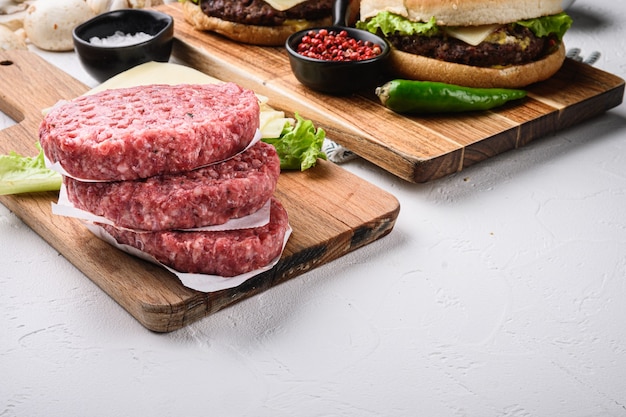 Raw beef with ingredients for a burger