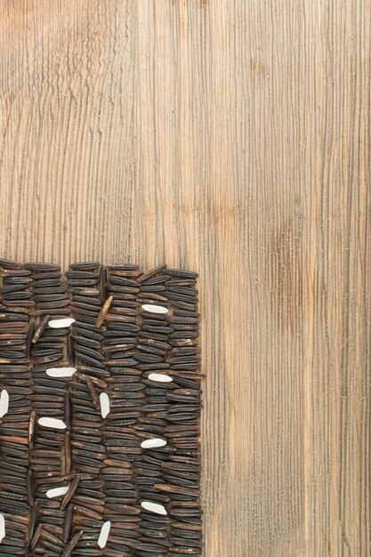 Raw Black Wild Rice on Wood Background