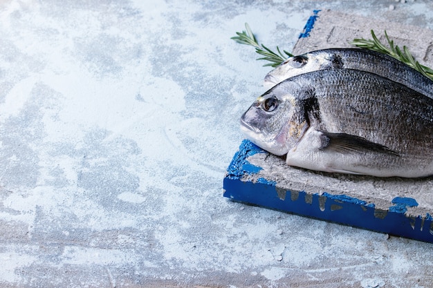 Raw bream fish with herbs