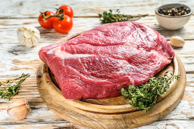 Photo raw brisket beef cut on a wooden board