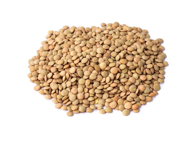 Raw brown lentils isolated over white background