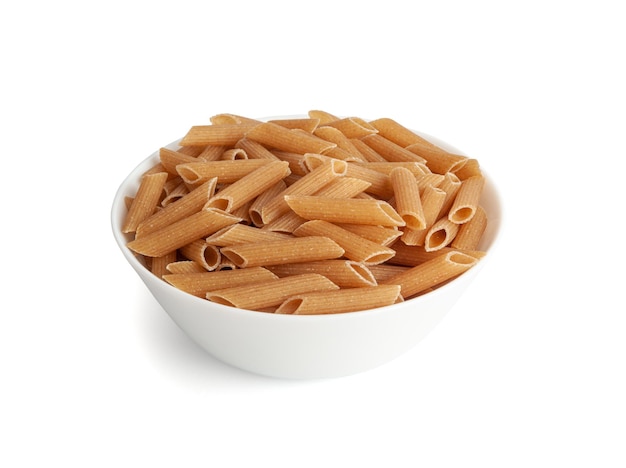 Raw Brown Pasta Isolated Wholegrain Penne Pile in Bowl Dry Whole Grain Noodle Raw Spelt Macaroni Healthy Italy Food Organic Meal Wholewheat Pasta on White Background