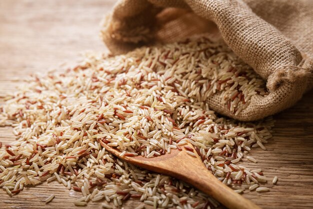 Raw brown rice on a wooden table