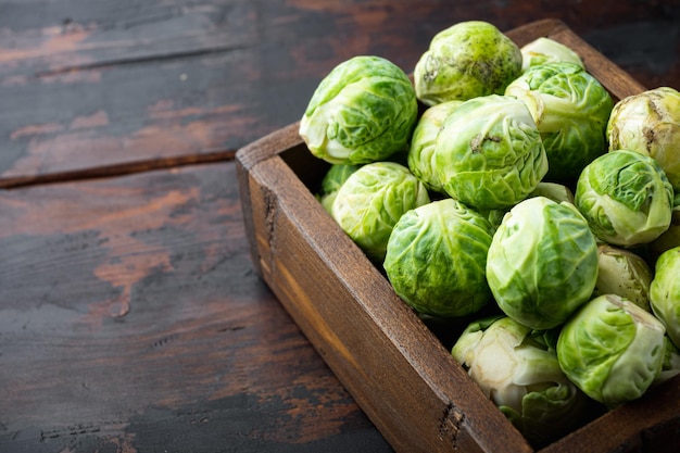 Raw brussels sprouts, on old wooden table with space for text