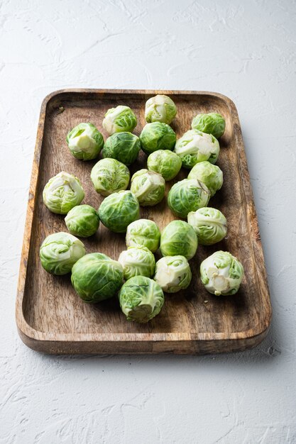 Raw brussels sprouts, on white textured background