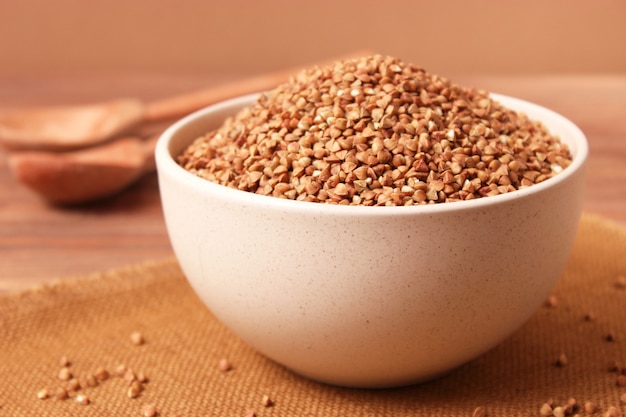 Raw buckwheat on a colored background closeup