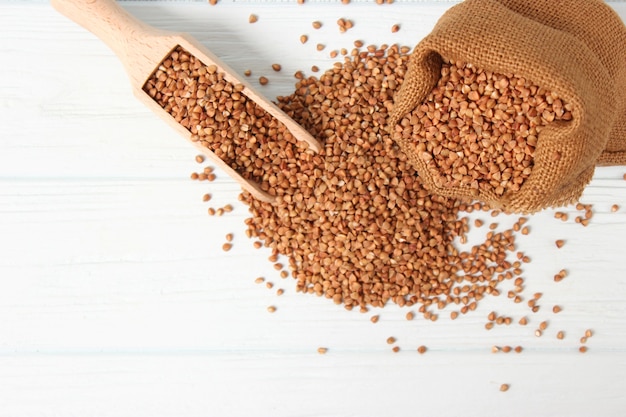 Raw buckwheat on a colored background closeup