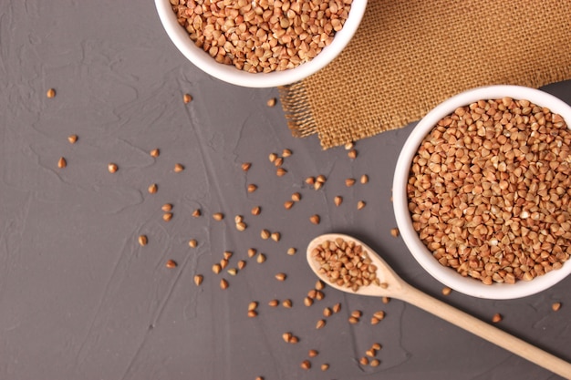 Raw buckwheat on a colored background closeup