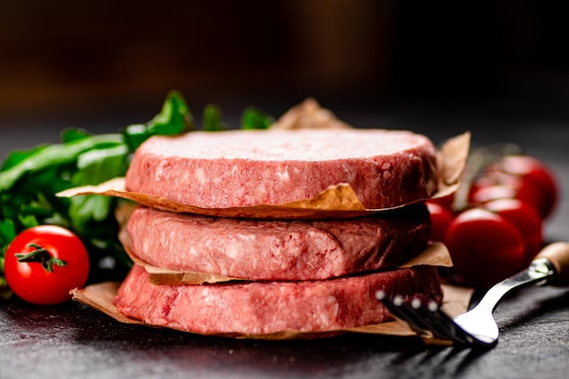 Raw burger with tomatoes and parsley