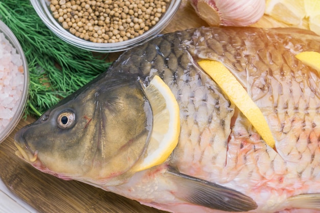 Raw carp fish stuffed with lemon slices Fish cooking recipe