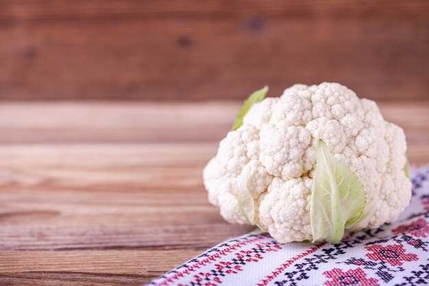 Raw cauliflower on wood