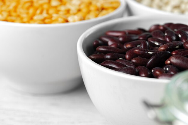 Raw cereals or beans in glass bowls