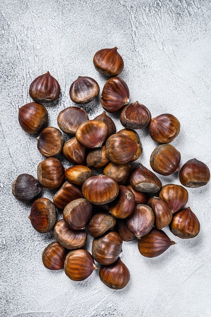 Raw chestnuts on a wooden table.