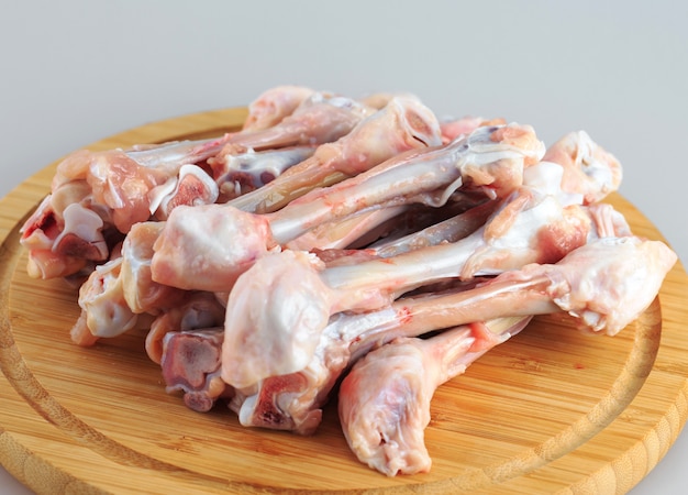 Raw chicken bones on white