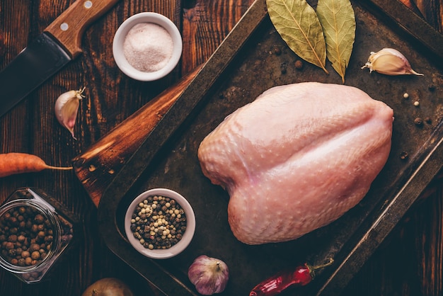 Raw chicken breast on baking sheet