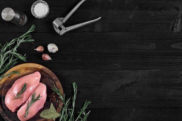 Photo raw chicken breast and condiments in a rustic wooden setting top view