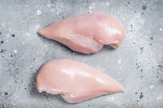 Photo raw chicken breast fillet on butcher table gray background top view