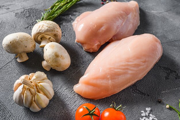 Raw chicken breast with fresh rosemary garlic, pepper and mushrooms