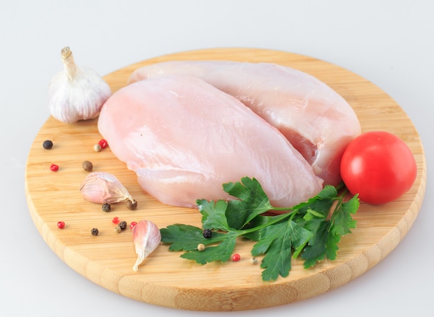 Raw chicken Breasts on a white