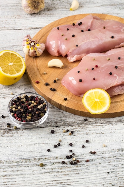 Raw chicken breasts with lemon pepper and garlic